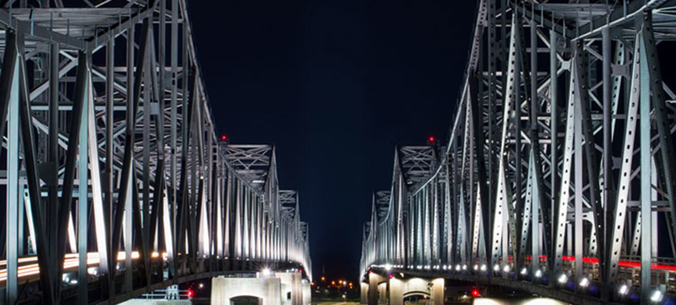 Photo of twin, well lit bridges spanning the Mississippi river