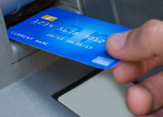 Photo of a Debit card being inserted into an ATM